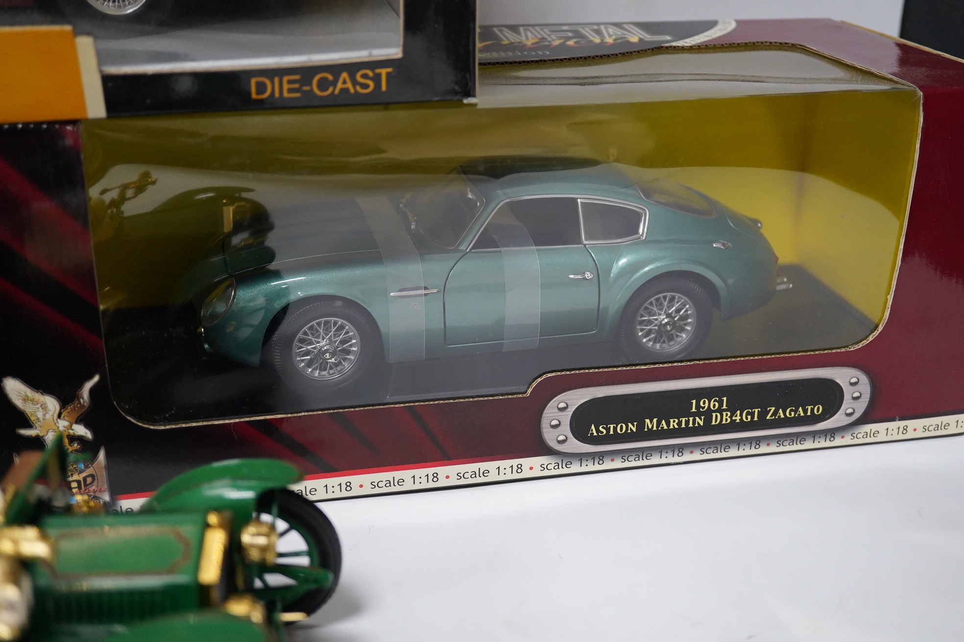 Five boxed large scale diecast cars; a 1:16 scale Franklin Mint 1905 Rolls-Royce 10hp, with one wheel detached and one side lamp detached (both present), together with four 1:18 scale cars; a Chrono Aston Martin DB5, a R